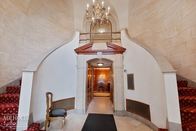 interior space featuring a chandelier and light tile floors