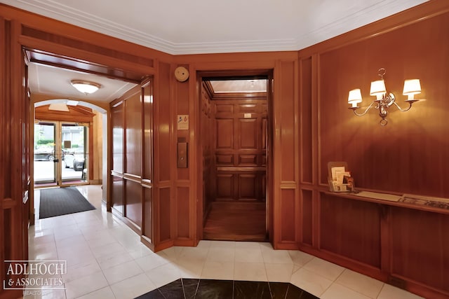 hallway featuring ornamental molding, light tile floors, and an inviting chandelier