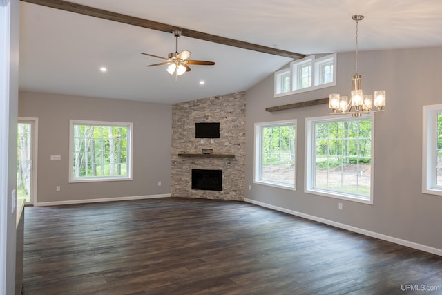 unfurnished living room with beamed ceiling, a wealth of natural light, dark hardwood / wood-style floors, and a stone fireplace