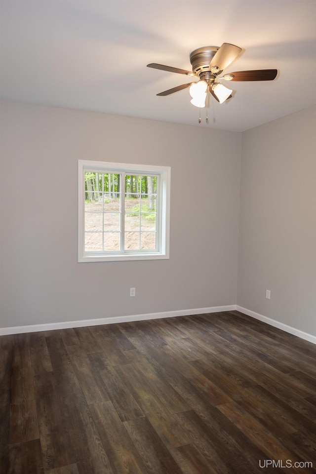 empty room featuring ceiling fan and dark hardwood / wood-style flooring