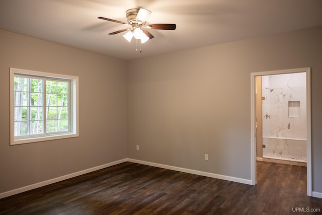 spare room with ceiling fan and dark wood-type flooring