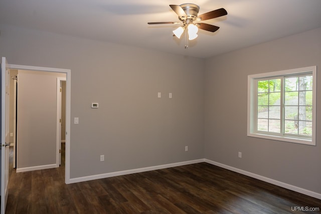 empty room featuring dark wood-type flooring and ceiling fan