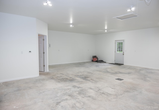 unfurnished room featuring concrete floors