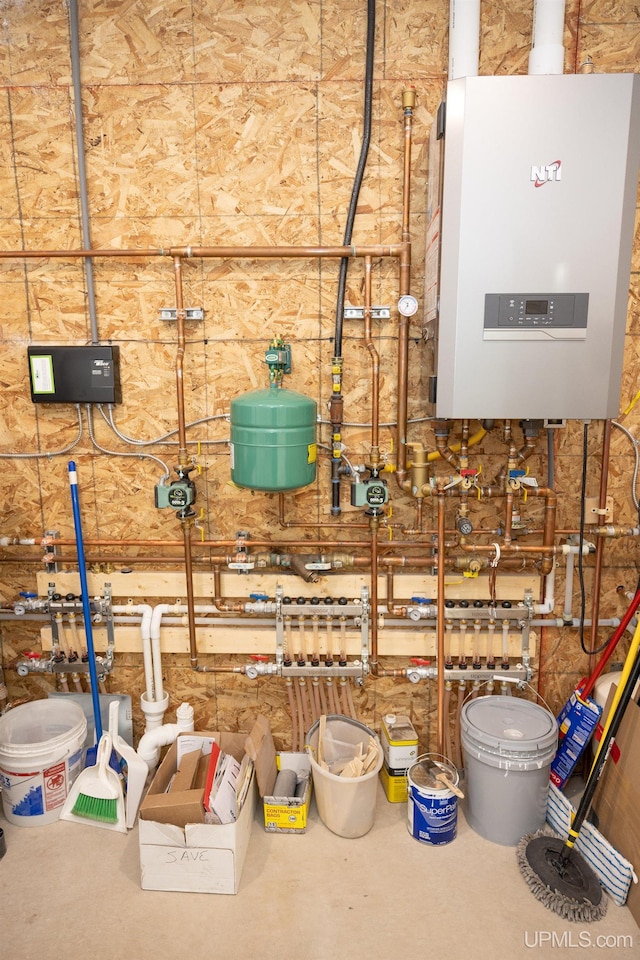 utility room featuring tankless water heater