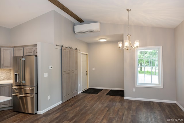 kitchen featuring an AC wall unit, high end refrigerator, pendant lighting, and dark wood-type flooring