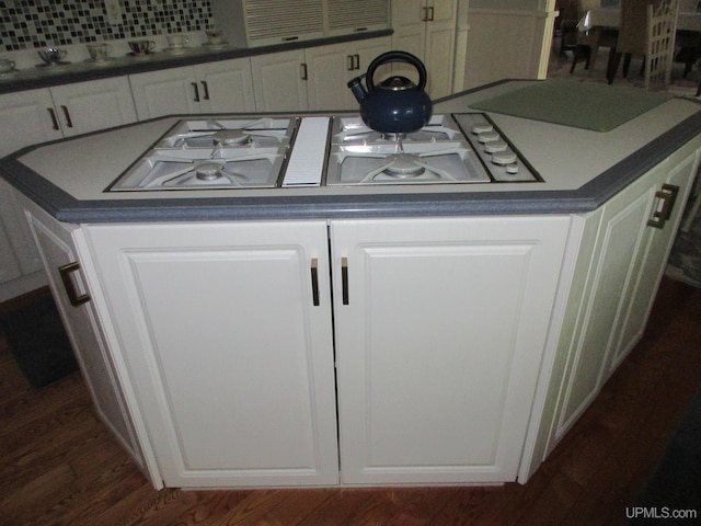 details with dark hardwood / wood-style floors, white cabinetry, and white stovetop