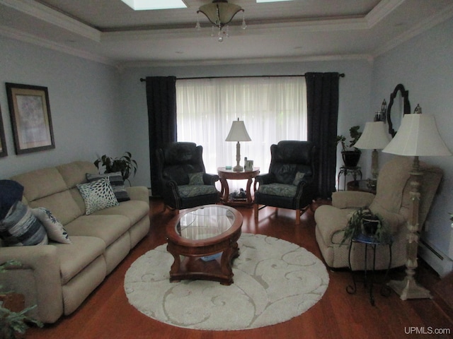 living room featuring ornamental molding, a raised ceiling, a skylight, and hardwood / wood-style floors