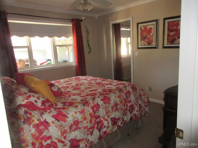 carpeted bedroom with ceiling fan and crown molding