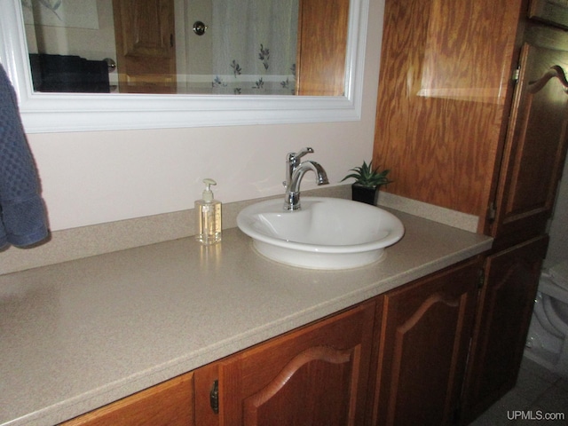 bathroom featuring vanity and toilet