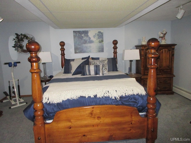 bedroom with carpet flooring and a drop ceiling