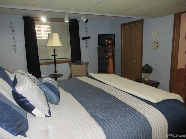 bedroom featuring a drop ceiling