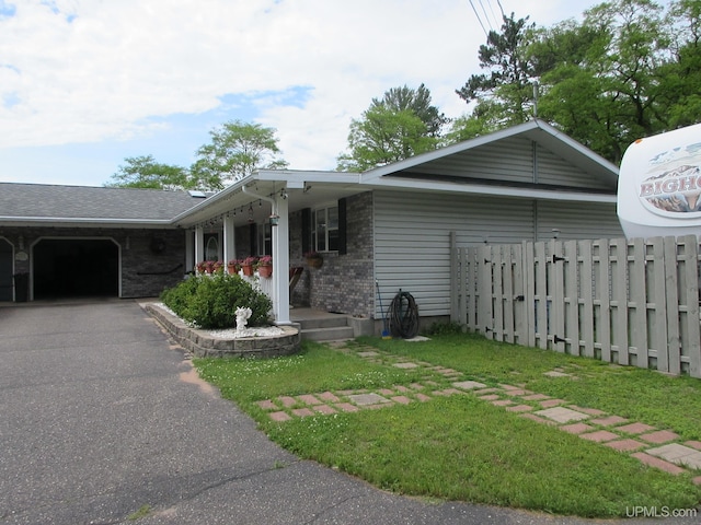 view of front of property featuring a front yard and a garage