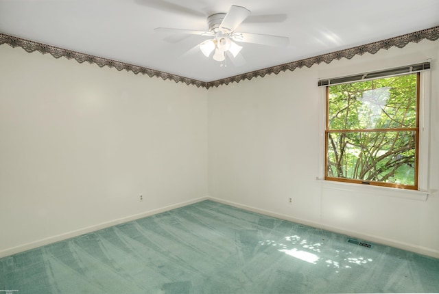 empty room featuring ceiling fan and carpet floors