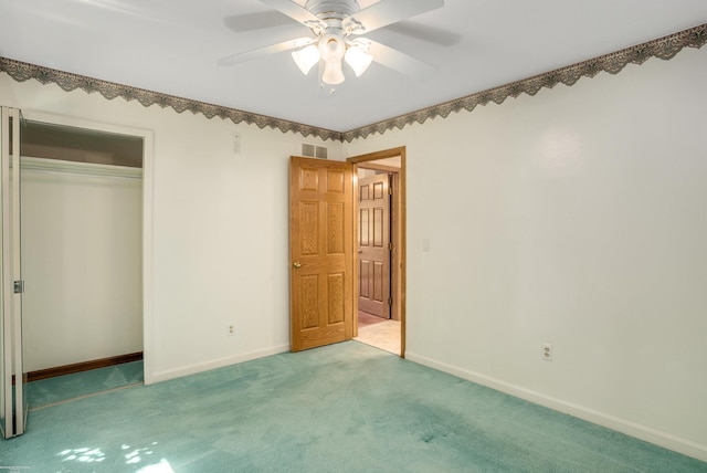 unfurnished bedroom featuring ceiling fan, light carpet, and a closet