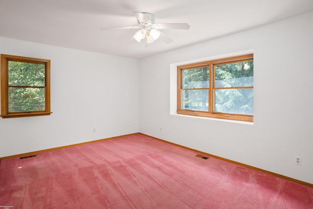 unfurnished room featuring ceiling fan and carpet floors