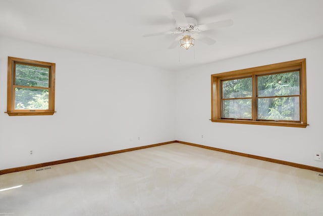 unfurnished room featuring ceiling fan, carpet floors, and a healthy amount of sunlight