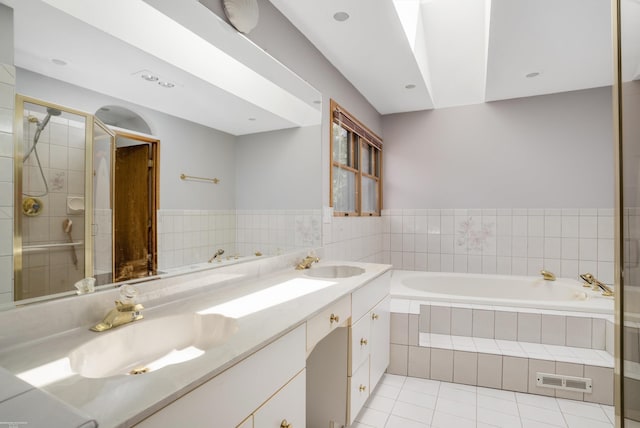 bathroom with tile patterned floors, separate shower and tub, and vanity