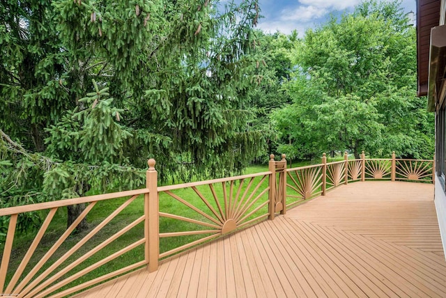 wooden deck featuring a yard