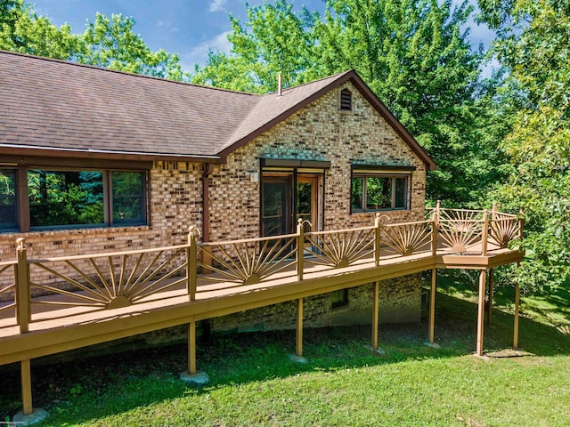 rear view of property with a yard, a wooden deck, and french doors