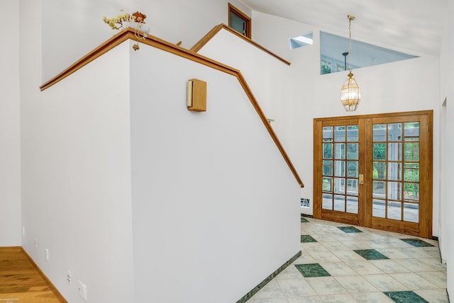 stairs featuring tile patterned floors, french doors, and a high ceiling