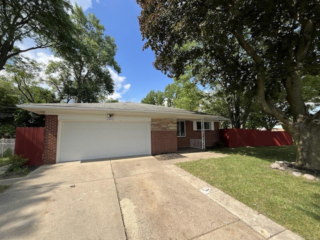 ranch-style home with a front lawn and a garage