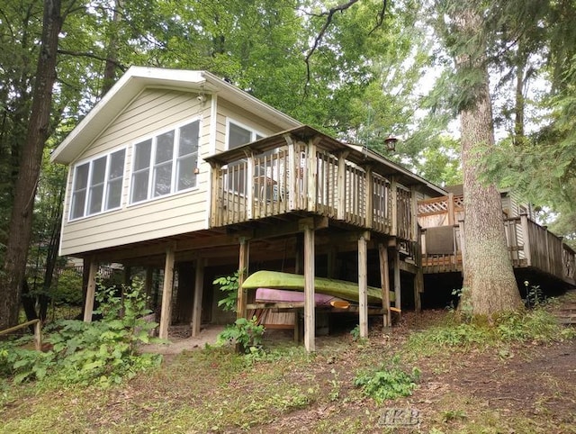 back of house with a wooden deck