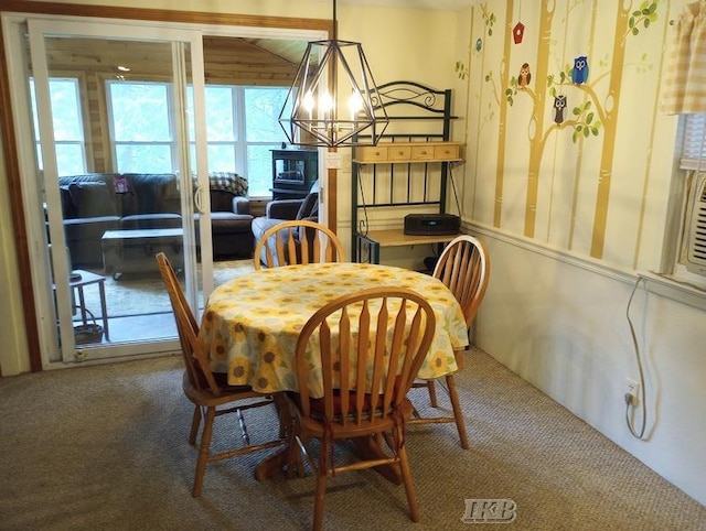 carpeted dining room featuring an inviting chandelier