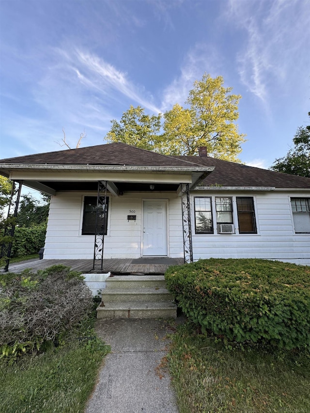 view of front of house with a porch and a shingled roof