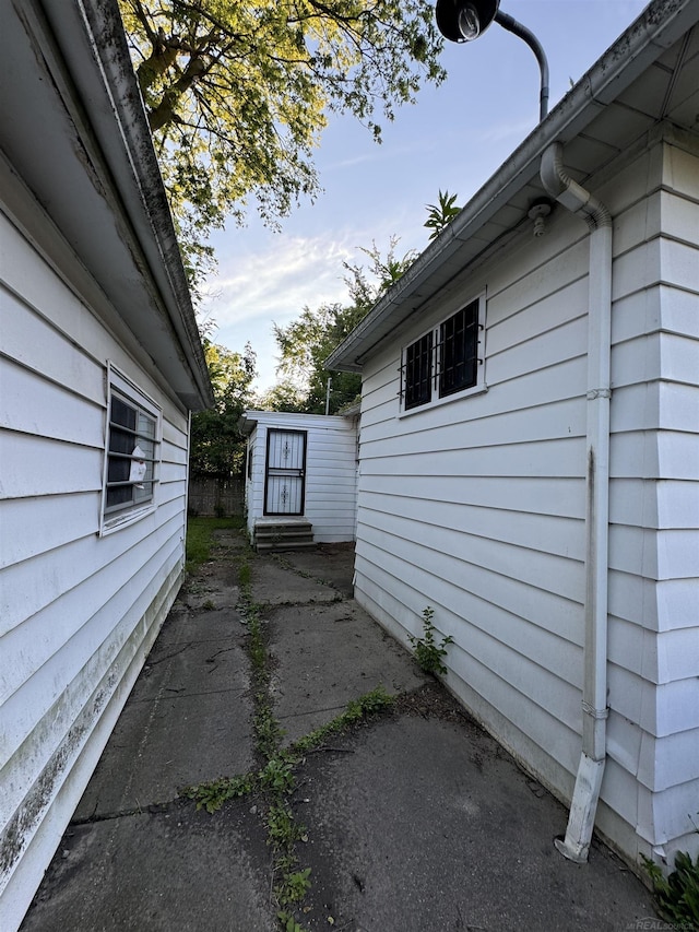 view of side of property with entry steps and a patio area