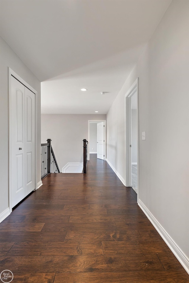 hall with dark wood-type flooring