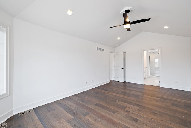 unfurnished bedroom with ceiling fan, lofted ceiling, dark wood-type flooring, and connected bathroom