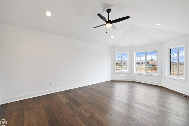 unfurnished room featuring ceiling fan, dark hardwood / wood-style flooring, and vaulted ceiling