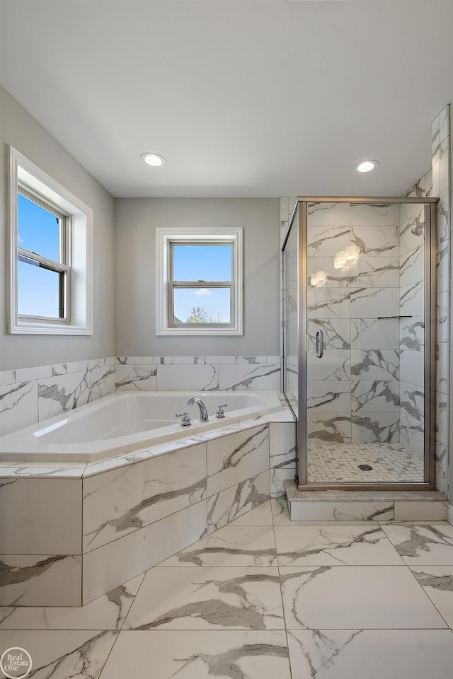 bathroom featuring plenty of natural light and plus walk in shower