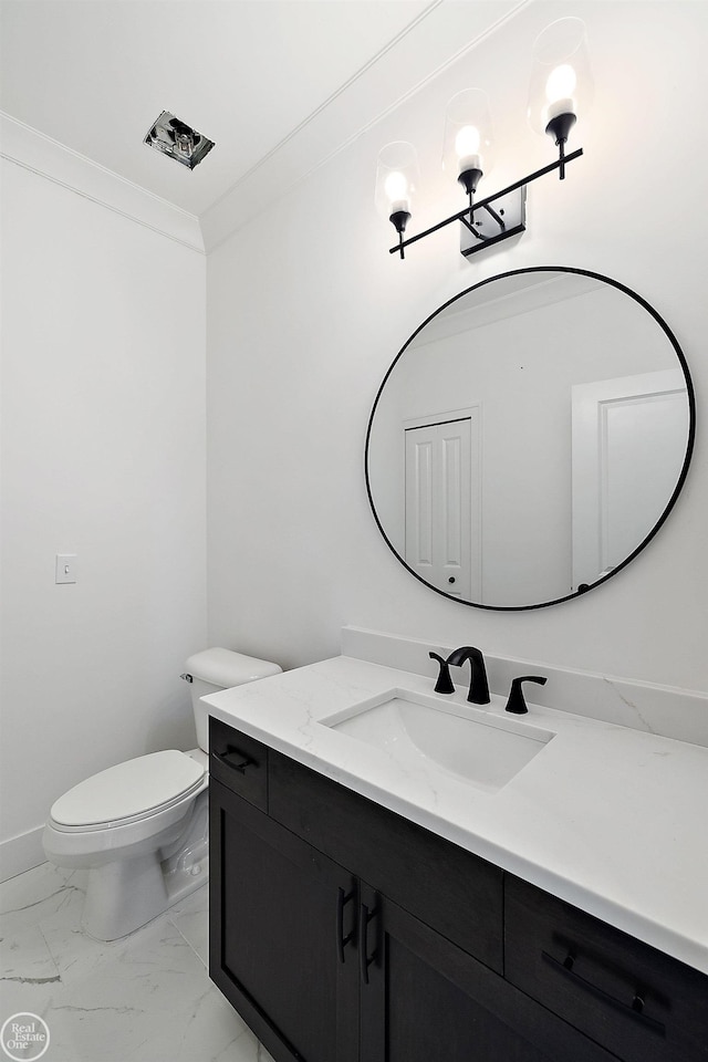 bathroom featuring vanity, toilet, and crown molding