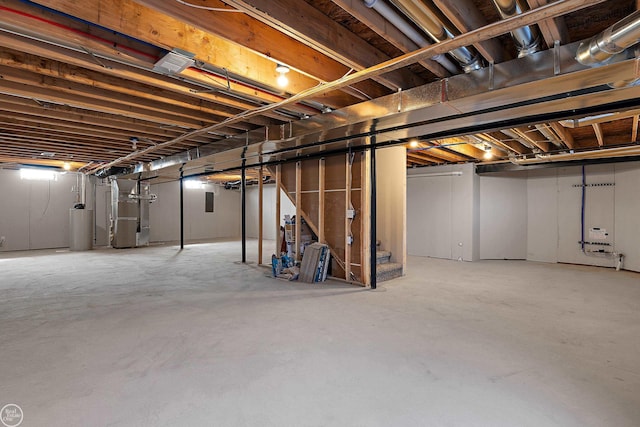 basement featuring heating unit and water heater