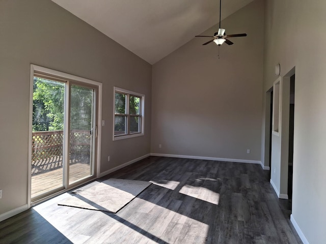 empty room featuring dark wood-type flooring, ceiling fan, and high vaulted ceiling