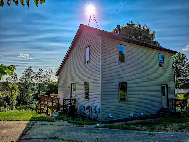 view of side of home with central AC unit