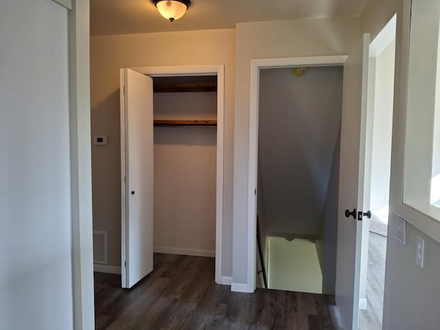 unfurnished bedroom featuring a closet and dark hardwood / wood-style floors