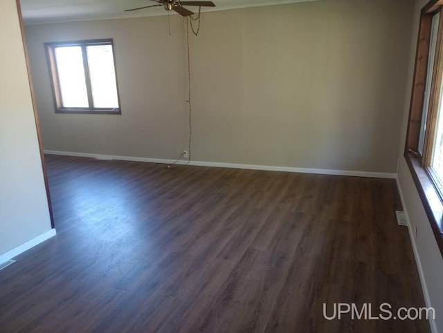 spare room featuring ceiling fan and dark hardwood / wood-style floors