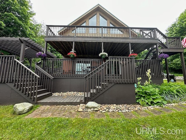 rear view of property featuring a wooden deck