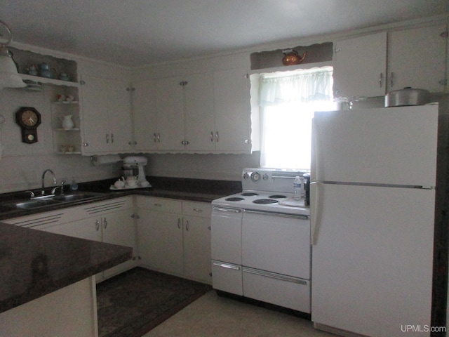 kitchen with white cabinetry, white appliances, and sink