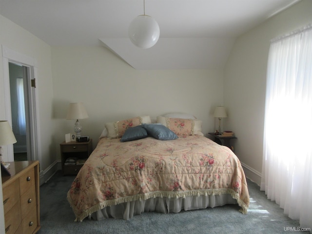 bedroom with vaulted ceiling and dark carpet