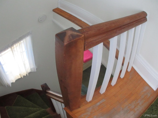 stairway with hardwood / wood-style flooring