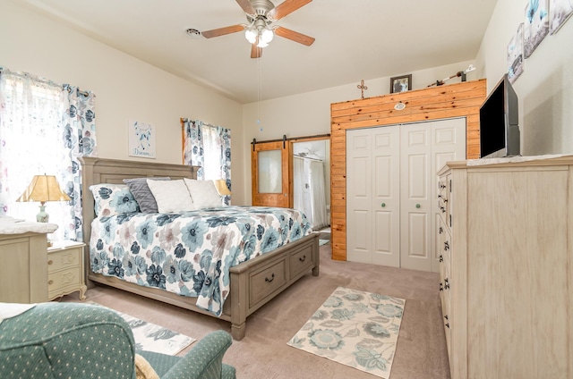 carpeted bedroom with ceiling fan, multiple windows, and a closet