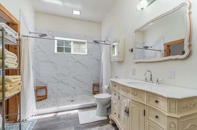 bathroom with hardwood / wood-style flooring, vanity, toilet, and a shower with shower curtain