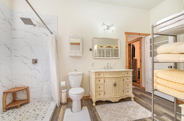 bathroom featuring toilet, vanity, wood-type flooring, and a shower with shower curtain