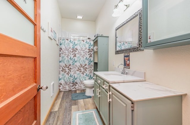 full bathroom with hardwood / wood-style floors, vanity, toilet, and shower / bath combo