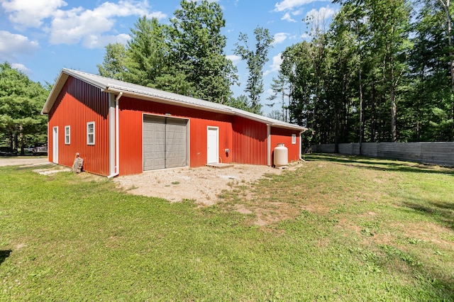 exterior space featuring a garage and a yard