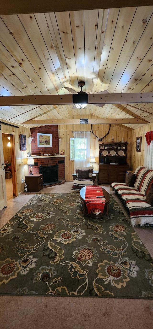 carpeted living room with wood ceiling and wood walls