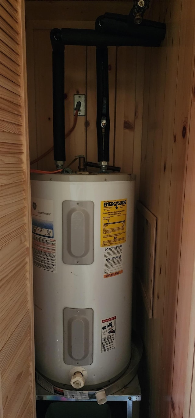 utility room featuring electric water heater